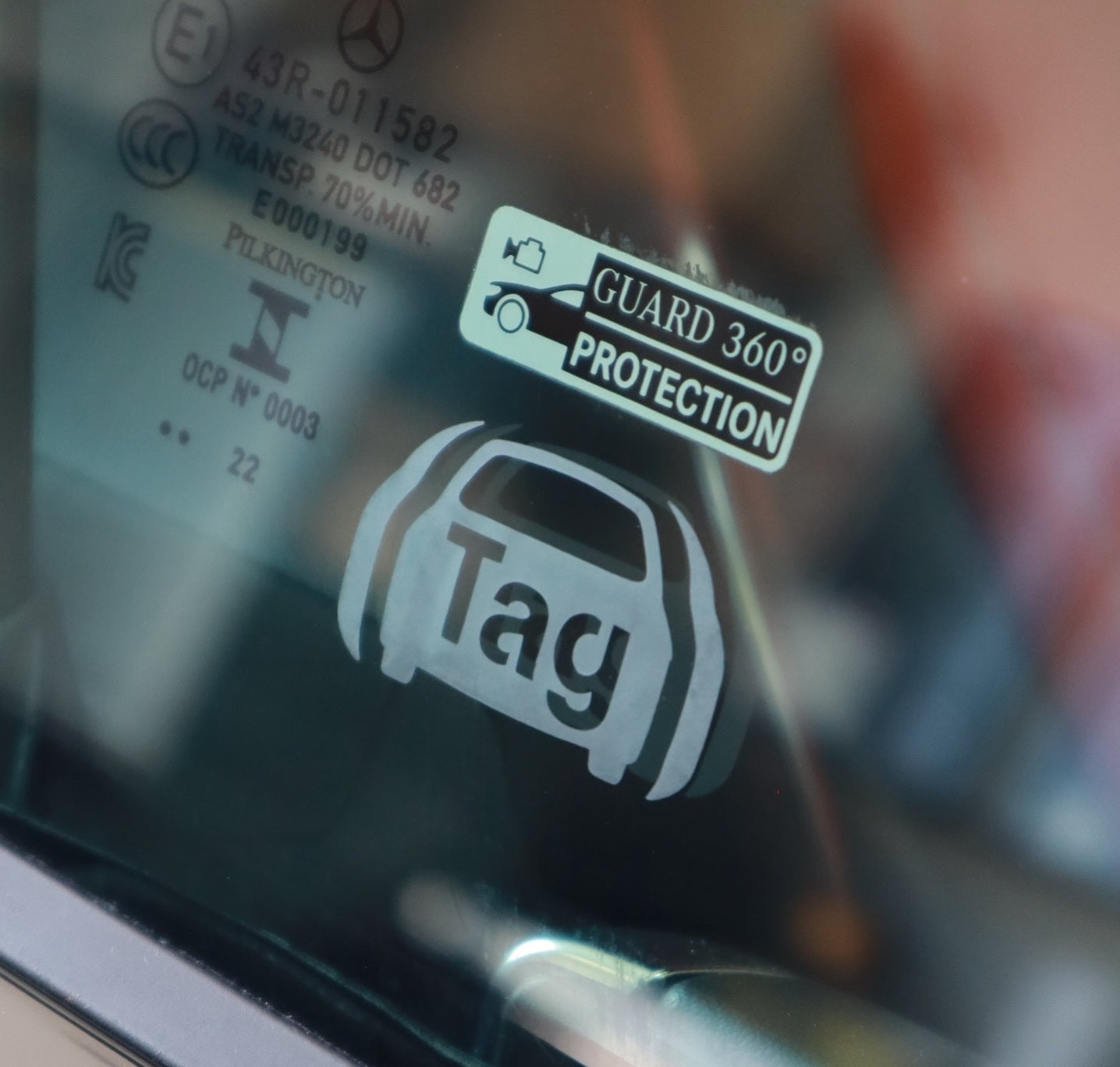 Close-up of a car window showing TAG GPS Tracking & Stolen Vehicle Recovery System - Ontario decal with professional installation.