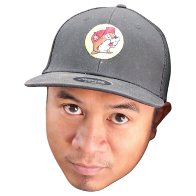 Man wearing black cap featuring cartoon beaver logo on front, isolated on white background