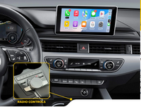 Vehicle dashboard featuring multimedia touchscreen with app icons and highlighted control dial for radio functions.