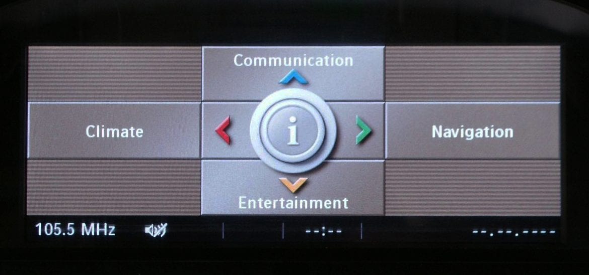 Car infotainment system screen showing communication, climate, navigation, and entertainment options with frequency display.
