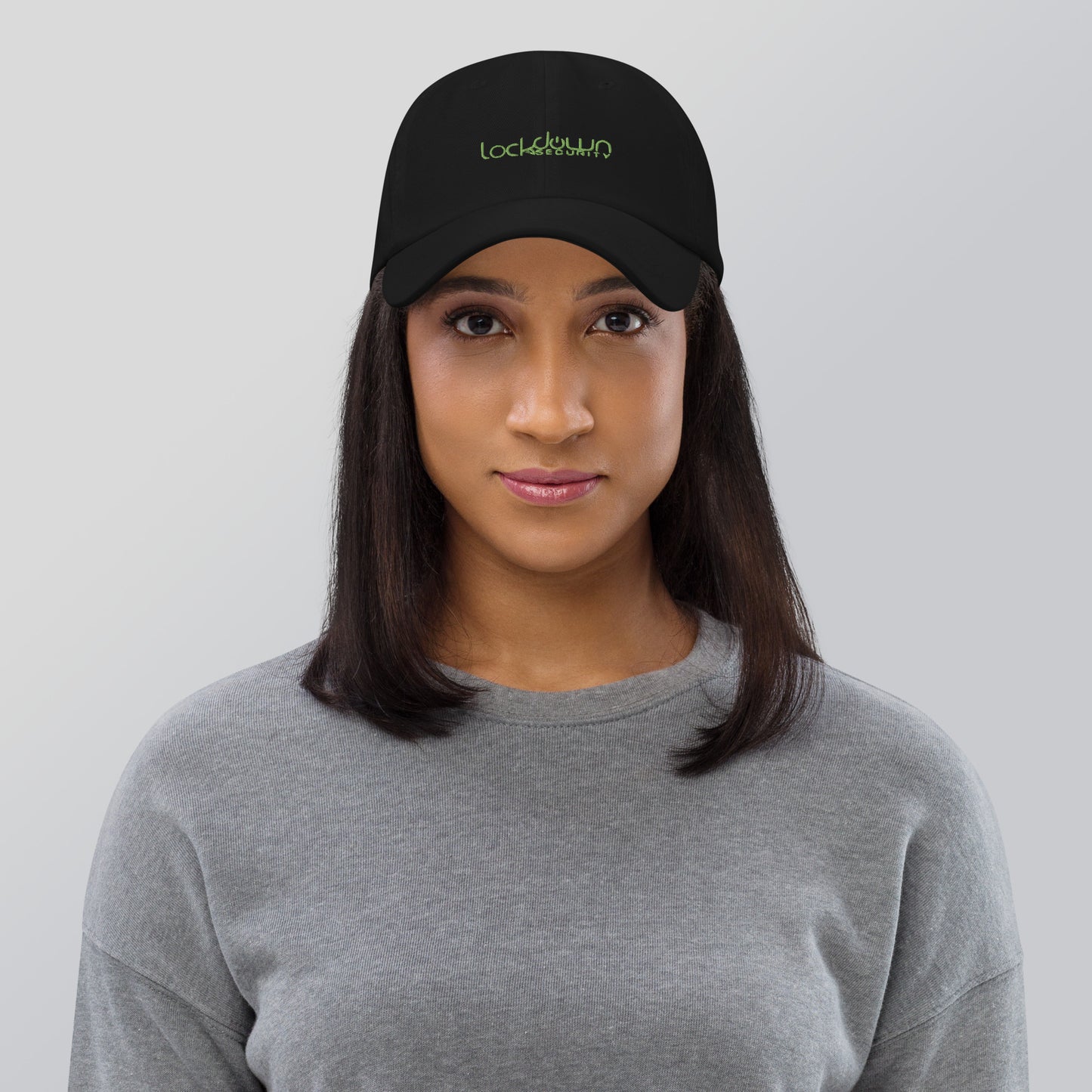 Woman wearing black Lockdown Security - Dad hat with green logo, promoting fast shipping and professional installation.