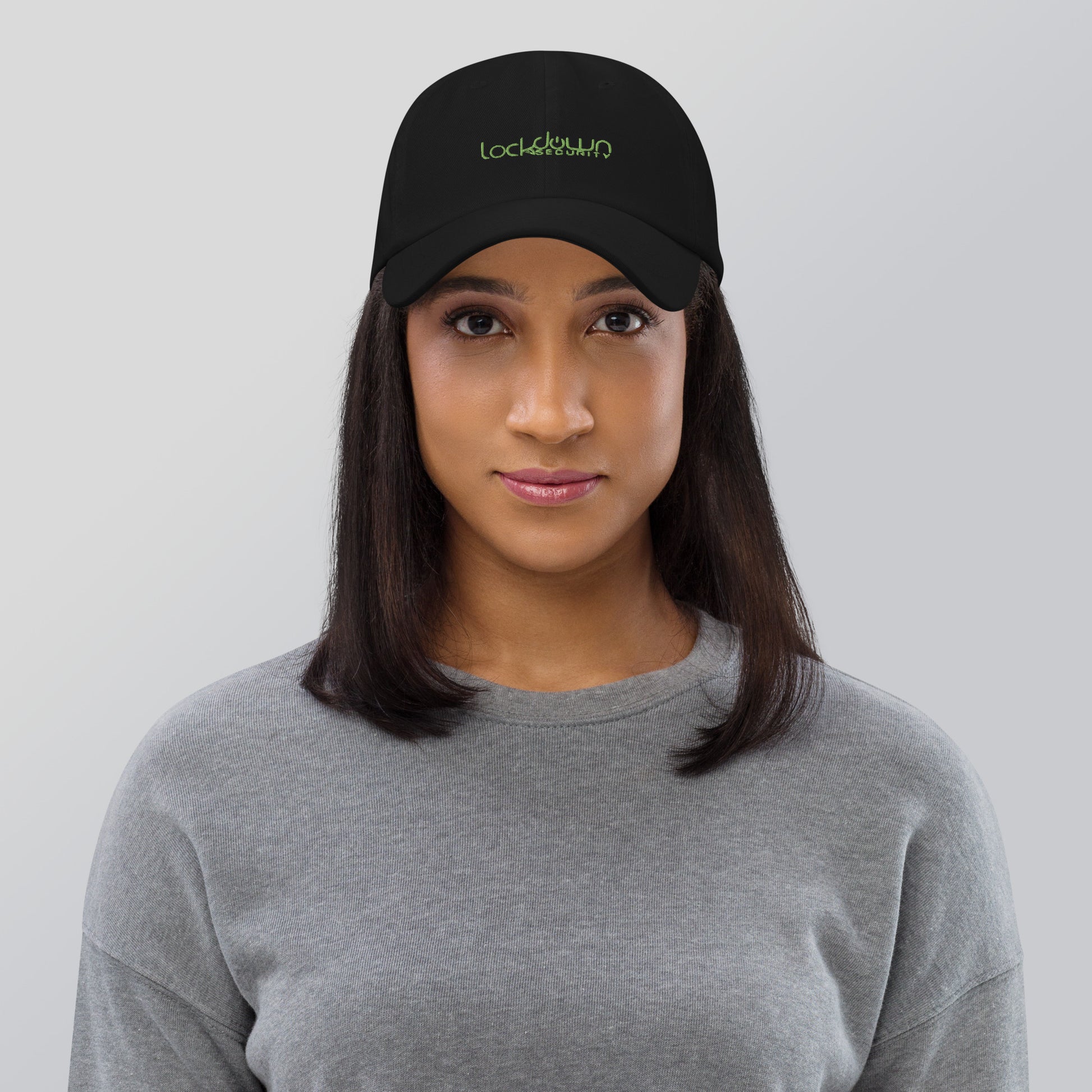 Woman wearing black Lockdown Security - Dad hat with green logo, promoting fast shipping and professional installation.